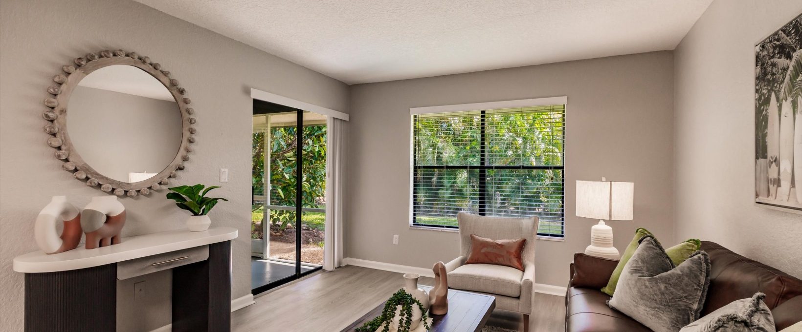 a living room with a couch, coffee table and television at The Marino