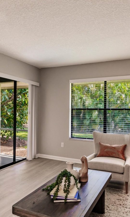 a living room with a couch, coffee table and television at The Marino