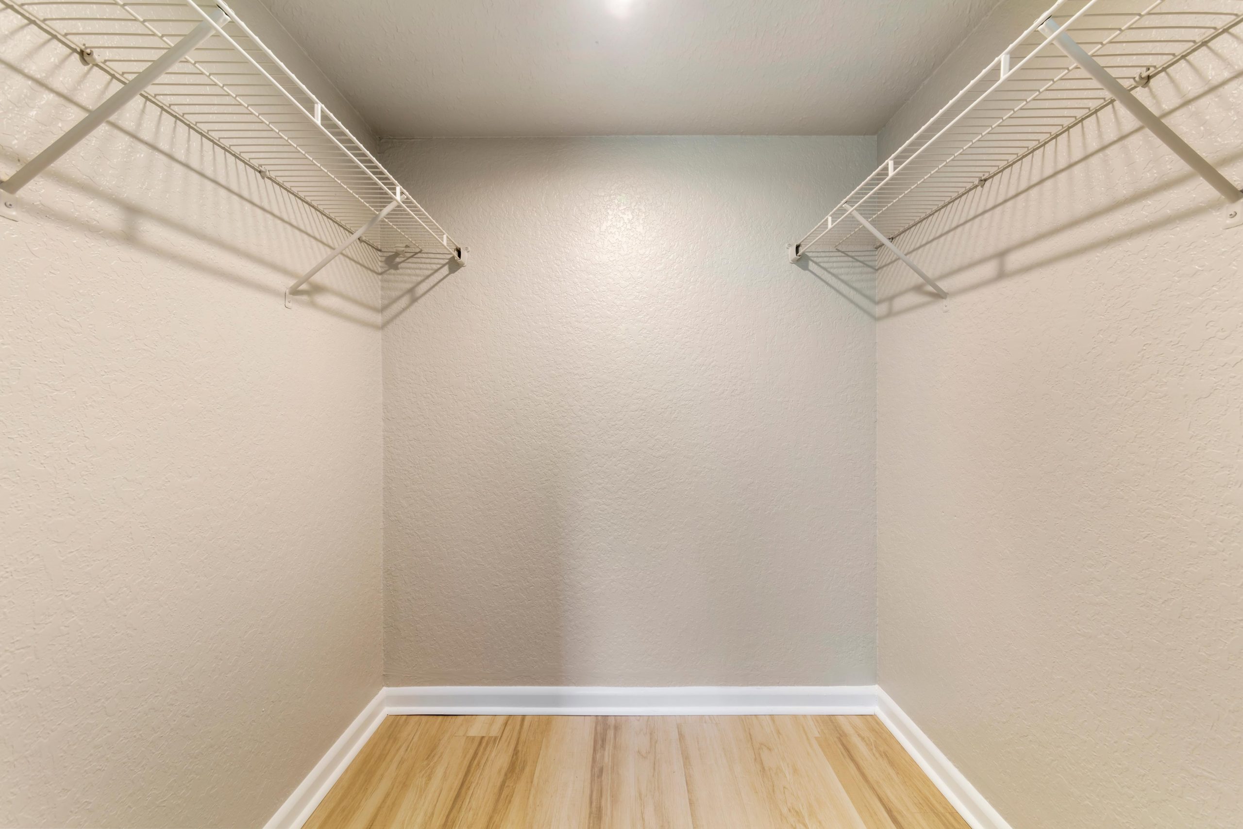 a empty closet with a wooden floor and a light fixture at The Marino