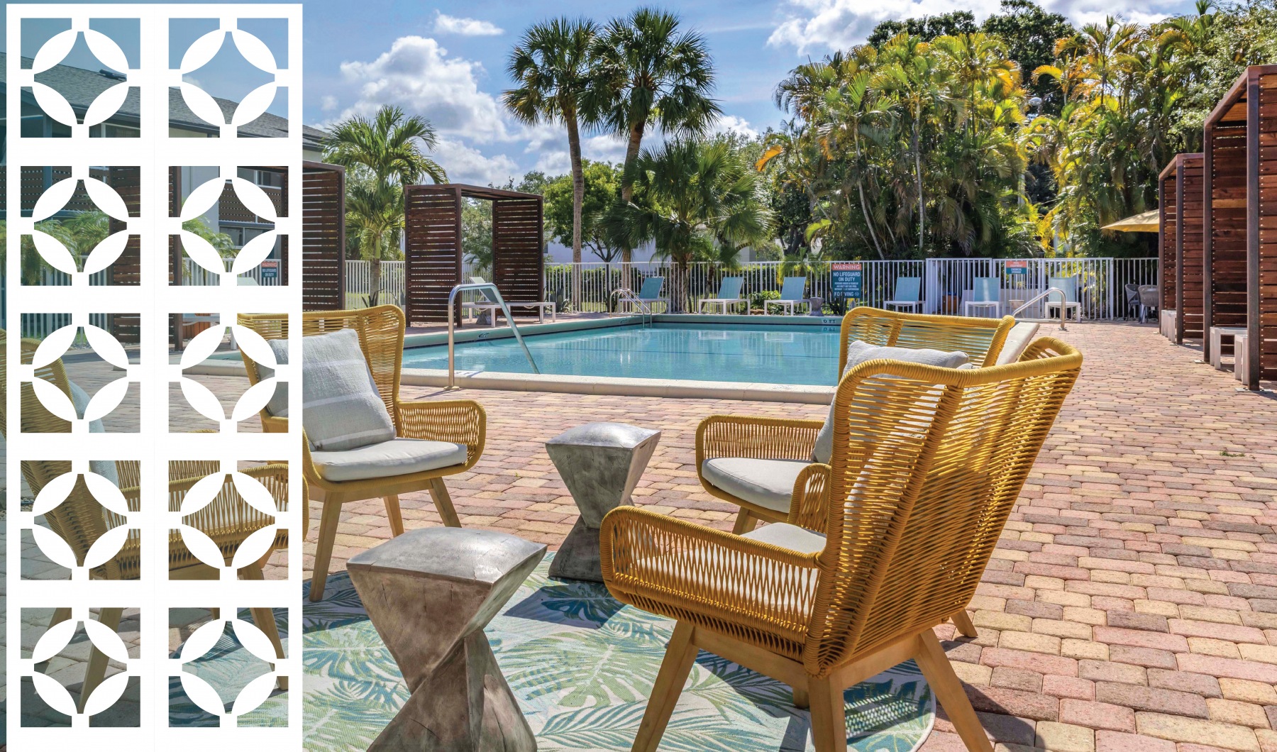 a pool and patio area with chairs and a table at The Marino