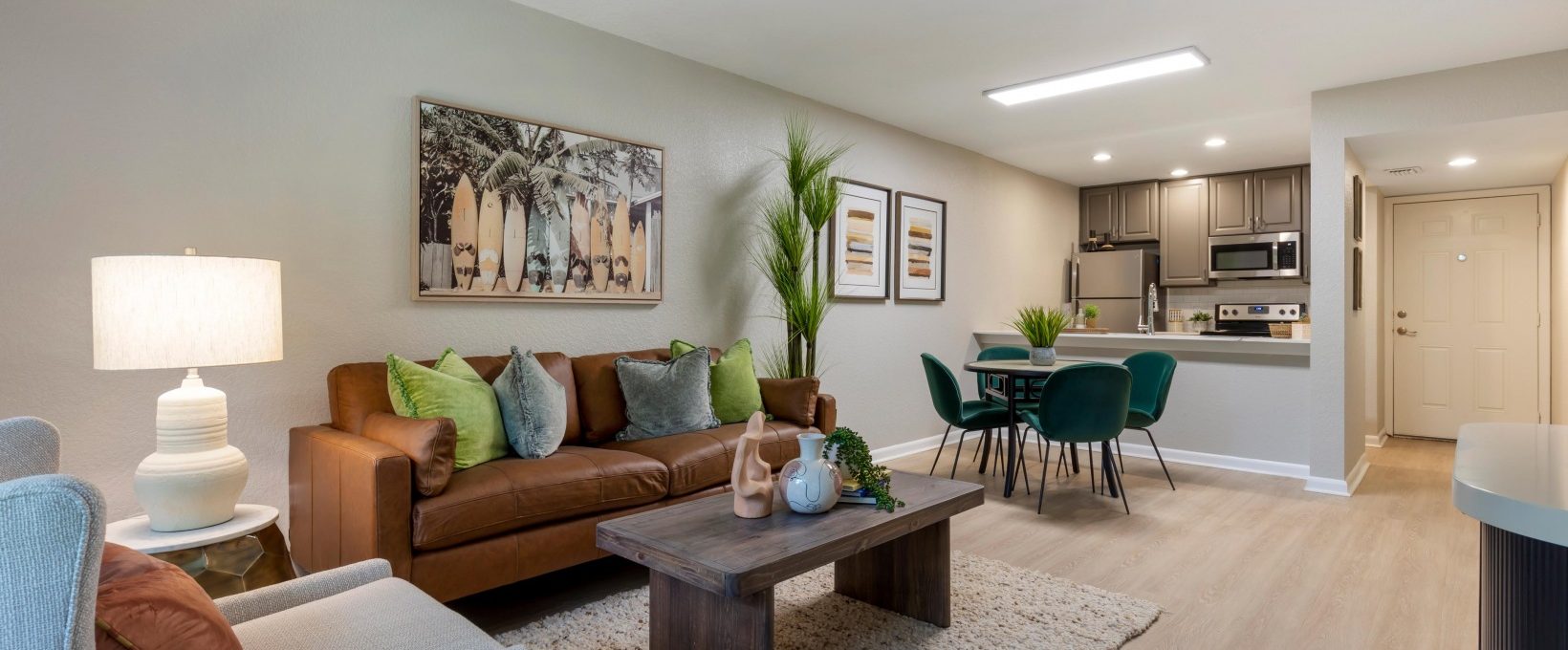 a living room and kitchen area with furniture at The Marino