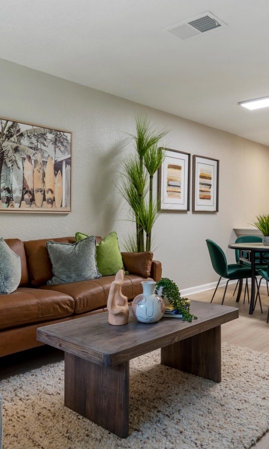 a living room and kitchen area with furniture at The Marino