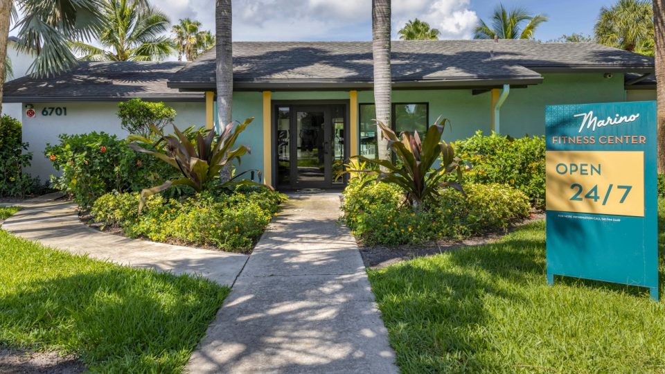 a home with a sign that says welcome to the community at The Marino